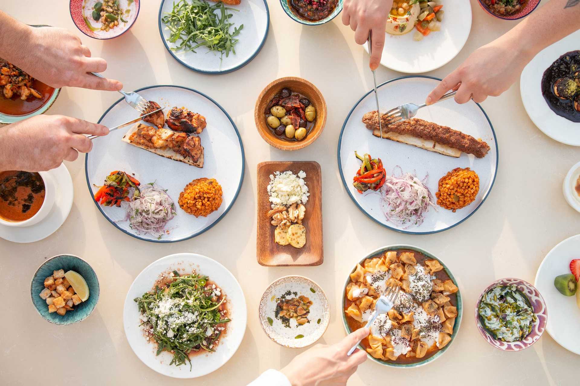 Overhead table with dishes of Mediterranean food